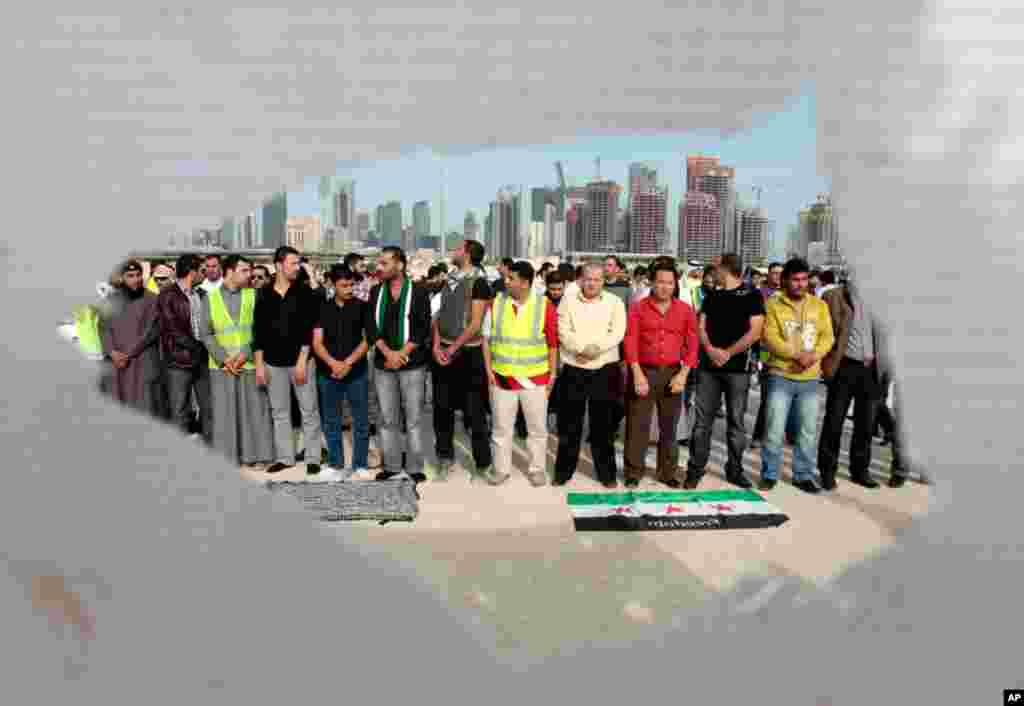 Syrians living in Qatar hold prayers for the victims who were killed during the attacks in Homs, February 8, 2012. (Reuters)