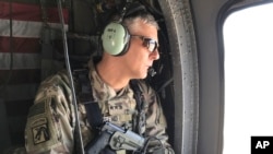 FILE - Then-Lt. Gen. Stephen Townsend flies north of Baghdad, Iraq, Feb. 8, 2017. Now a general and head of U.S. Africa Command, he says the U.S. knows the Chinese "desire a network of bases around the globe."