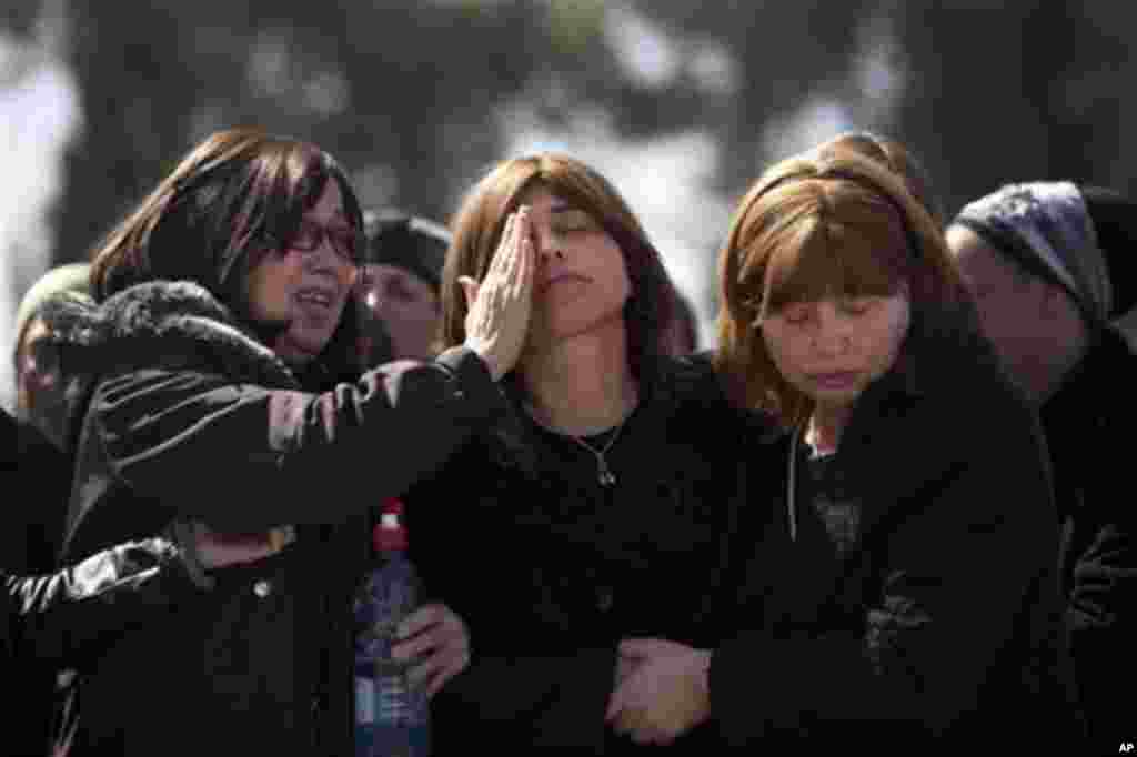 Family members react during a funeral for the victims of Monday's shooting in Toulouse at a cemetery in Jerusalem, Wednesday, March. 21, 2012. A rabbi and three children gunned down at a Jewish school in France were buried Wednesday in a Jerusalem cemeter