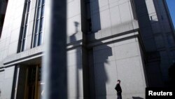 FILE - A court officer walks outside the federal Courthouse in Manhattan, April 19, 2019.