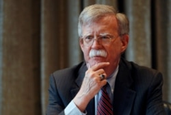 FILE - White House national security adviser John Bolton meets with journalists in London, Aug.12, 2019.