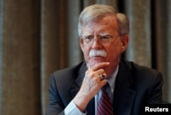 FILE - White House national security adviser John Bolton meets with journalists in London, Aug.12, 2019.