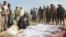 Afghan villagers gather around several victims' bodies who were killed during clashes between Taliban and Afghan security forces in Taliban's controlled village, Buz-e Kandahari village in Kunduz province, north of Kabul, Afghanistan, Friday, Nov. 4, 2016.