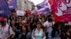 Demonstrators take part in a protest against French Prime Minister Michel Barnier and the new government, in Paris, Sept. 21, 2024.