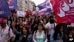 Demonstrators take part in a protest against French Prime Minister Michel Barnier and the new government, in Paris, Sept. 21, 2024.