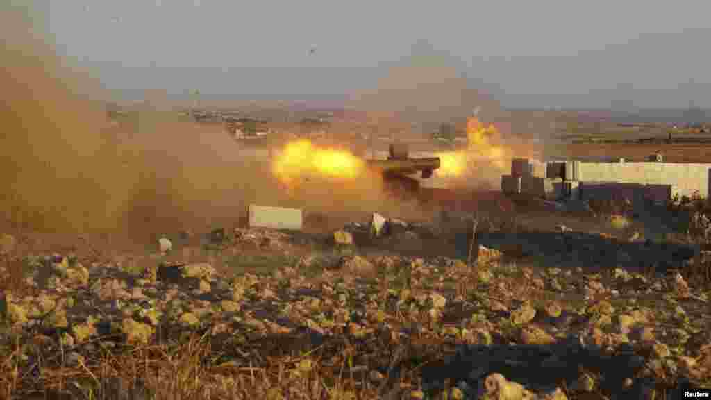 Free Syrian Army fighters fire anti-tank missiles during what they said were clashes with forces loyal to Syria's President al-Assad in the eastern Hama countryside, Oct. 14, 2013. 