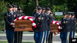 FILE - In this Sept. 6, 2018, photo, the 3rd Infantry Regiment, also known as the Old Guard, carries the remains of two unknown Civil War Union soldiers to their graves at Arlington National Cemetery in Arlington, Va. The U.S. Army is being criticized for reburying the remains of two recently discovered Civil War soldiers without conducting DNA testing. 