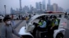 FILE - Police officers patrol Shanghai, China, June 1, 2022.