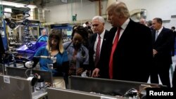 FILE - Donald Trump, president-elect at the time, tours a Carrier factory with vice president-elect Mike Pence in Indianapolis, Indiana, Dec. 1, 2016. 