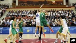 South and North Korean players of Team Peace, in white, and Team Prosperity play during a friendly basketball game at Ryugyong Jong Ju Yong Gymnasium in Pyongyang, North Korea, July 4, 2018. 