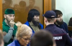 FILE - Shadid Gubashev (L), Anzor Gubashev (C), and Zaur Dadayev (R) are seen during the reading of their sentences at their trial in the murder of Russian opposition politician Boris Nemtsov, in a courtroom in Moscow, Russia, July 13, 2017.