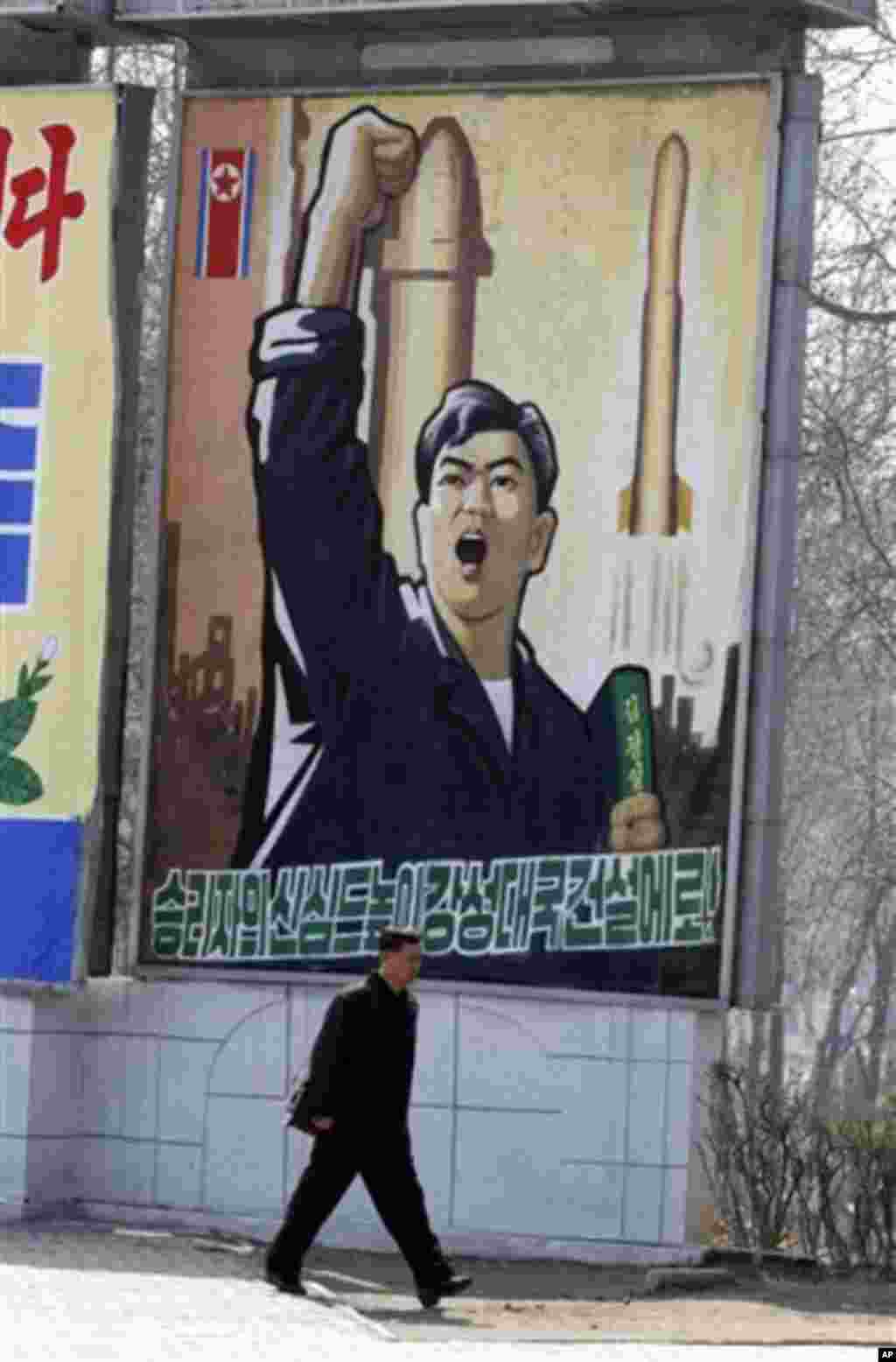 A North Korean man walks past a propaganda billboard in Pyongyang, North Korea, Friday, April 13, 2012. North Korea's much-anticipated rocket launch ended quickly in failure early Friday, splintering into pieces over the Yellow Sea soon after takeoff, acc