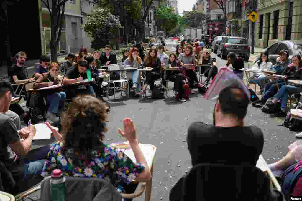 Students from the department of Philosophy and Letters at the University of Buenos Aires hold classes in the street to protest President Javier Milei's veto of a university funding law, in Buenos Aires, Argentina, Oct. 8, 2024. 