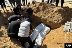 Palestinians bury bodies during a funeral in Beit Lahia, in the northern Gaza Strip, Oct. 29, 2024.