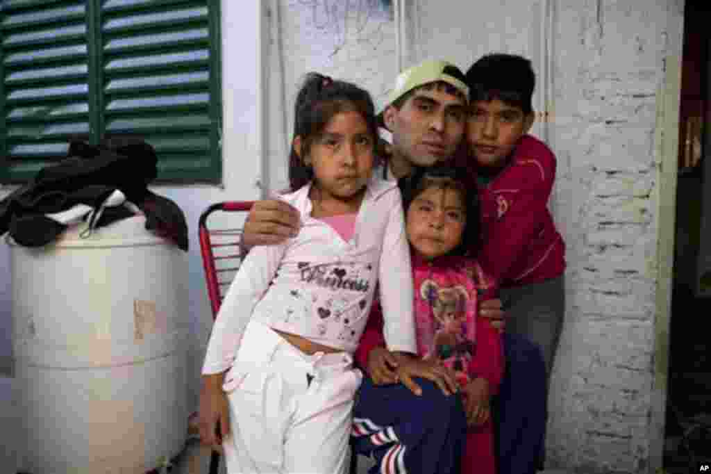 Cristian Marcelo Reynoso, center, poses inside his home with his children, Milagro, 5, left, Oriana, 3, bottom, and Nahuel, 10, right, in their home in the Villa 21-24 slum in Buenos Aires, Argentina, March 14, 2013. At Villa 21-24, a slum so dangerous that most outsiders wouldn&#39;t dare go in, Jorge Mario Bergoglio often showed up unannounced to share laughs and sips of mate, the traditional Argentina herbal tea.