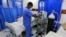 FILE - A health care worker attends to a COVID-19 patient inside the Intensive Care Unit ward equipped with supplemental oxyden, at the Care Hospital, Nairobi, Kenya, Aug. 4, 2021. 