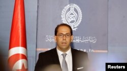 FILE - Tunisia's then-Prime Minister-designate Youssef Chahed speaks during a news conference in Tunis, Tunisia, Aug. 3, 2016. 
