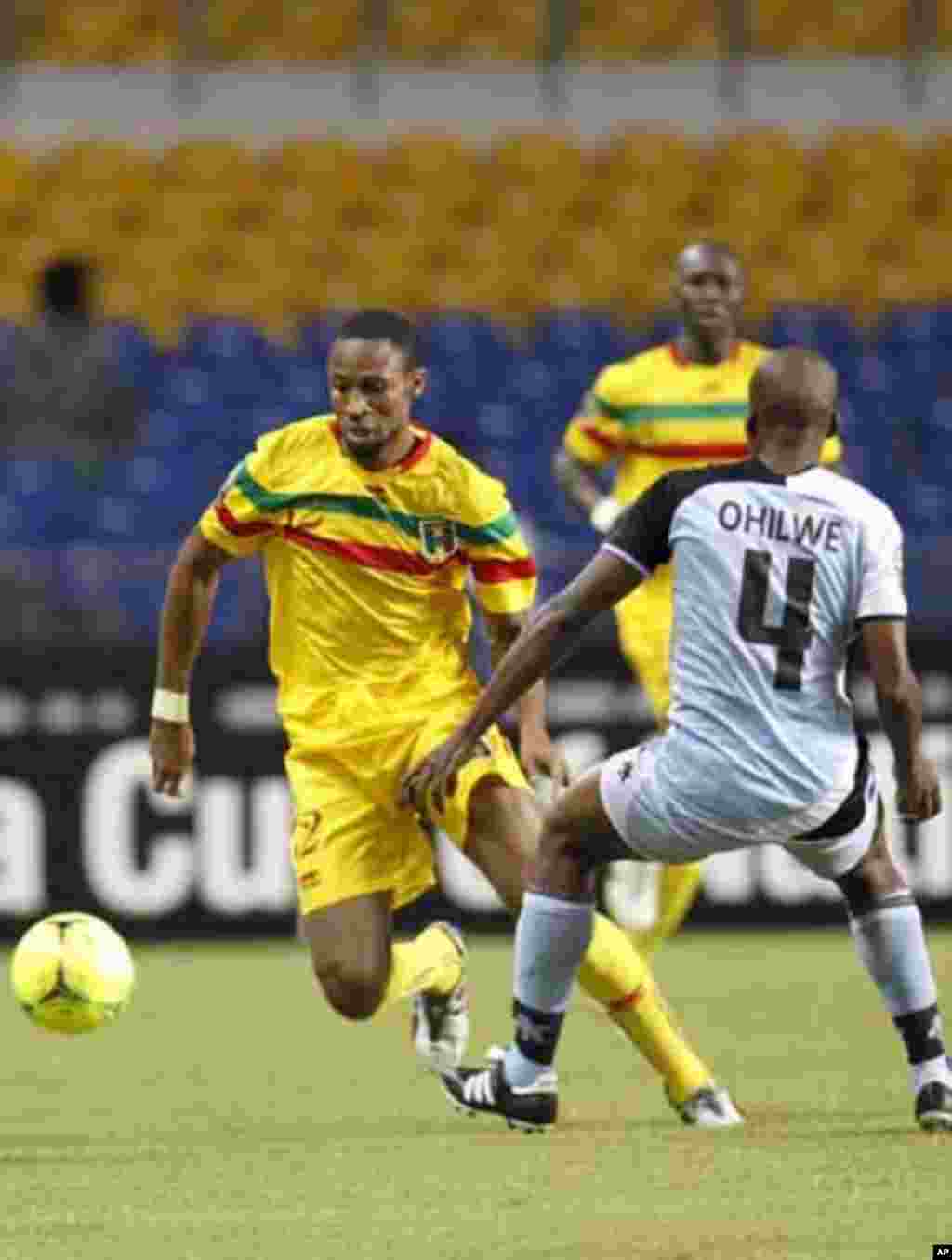 Mali's Seydou Keita (12) plays against Botswana's Mmusa Ohilwe during their final African Cup of Nations Group D soccer match at the Stade De L'Amitie Stadium in Libreville February 1, 2012.