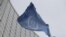 FILE - The flag of the International Atomic Energy Agency flies in front of its headquarters during an IAEA Board of Governors meeting in Vienna, Austria, on Feb. 6, 2023. 