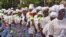 Liberia women walk, after praying for help with the Ebola virus, in the city of Monrovia, Liberia, Aug. 14, 2014.