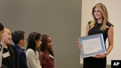 FILE - Melania Trump talks with third- and fourth-graders from the United Nations International School during a tour of the New York Stock Exchange in New York, Sept. 23, 2019.