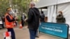 People wait outside a coronavirus disease (COVID-19) vaccination centre at Sydney Olympic Park in Sydney, Australia, July 14, 2021.