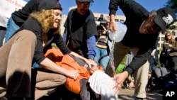 Protesters simulate the use of waterboarding on a volunteer at an anti-torture rally in front of the Justice Department in Washington, Nov. 5, 2007. (AP Photo/Manuel Balce Ceneta)