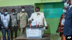 Guinean President Alpha Conde casts his ballot in Conakry, Guinea, Oct. 18, 2020.