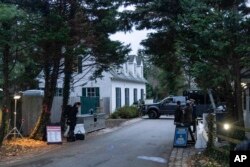 The access road to President Joe Biden's home in Wilmington, Del., is seen from a media van on Jan. 13, 2023. Senior Democratic lawmakers turned sharply more critical Sunday of President Joe Biden's handling of classified materials after the FBI discovered additional items with classified markings at Biden's home. (AP Photo/Carolyn Kaster, File)