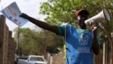 FILE - A South Sudanese health worker speaks on a megaphone during a campaign to vaccinate children against measles in Juba, South Sudan, Feb. 4, 2020.