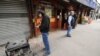 A local resident charges his cell phones from a generator connected to a 14th street market in the still powerless Chelsea section of Manhattan, New York, November 1, 2012.