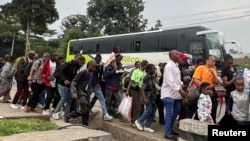 Humanitarian staff who fled from Goma, eastern Democratic Republic of the Congo, following fighting between M23 rebels and the armed forces of the Democratic Republic of the Congo, arrive in Gisenyi, Rwanda, Jan. 27, 2025. 