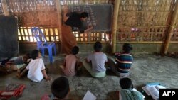 Rohingya refugee children study in a school at Kutupalong refugee camp, in Ukhia on Oct. 5, 2020.