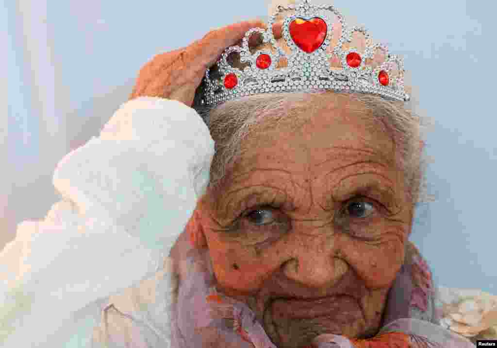 Margaret Maritz reacts at her 118-year birthday celebrations in Touwsrivier in the Western Cape province, South Africa.