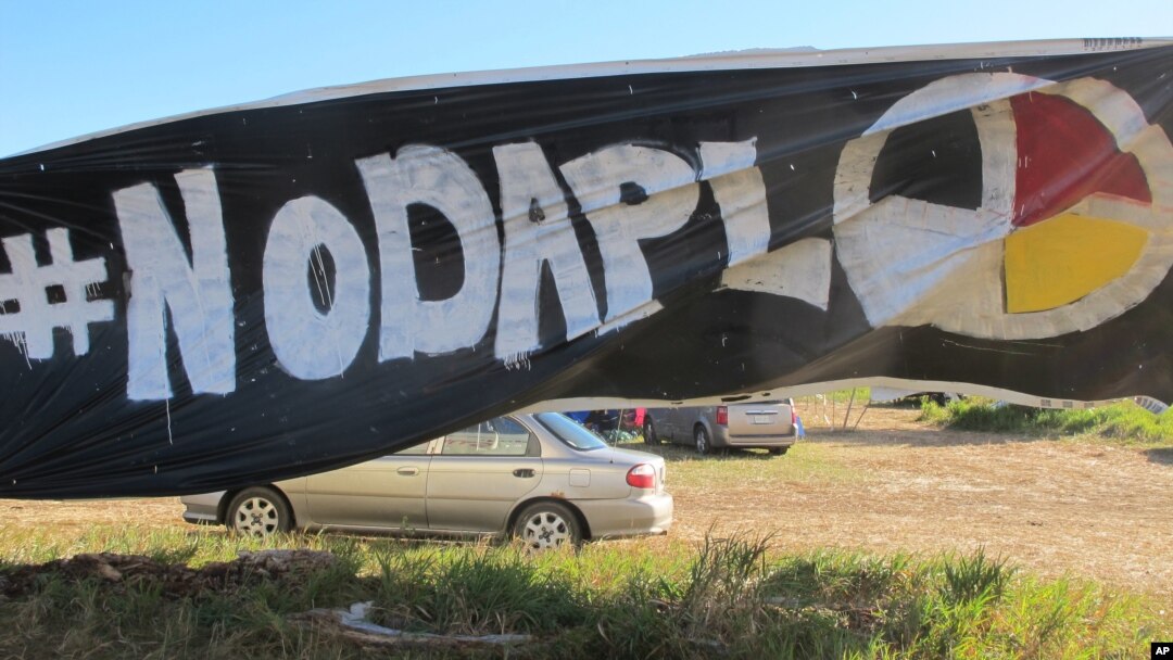 A banner protesting the Dakota Access oil pipeline is displayed at an encampment near North Dakota's Standing Rock Sioux reservation, Sept. 9, 2016. 