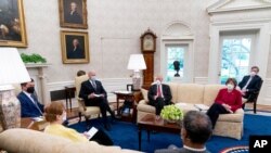 拜登总统在白宫椭圆形办公室与运输部长布蒂吉格(左)和国会议员们会面，讨论他的就业计划。(2021年4月19日)