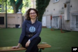 Rabbi Ilana Baird, who volunteers to mentor Ukrainian refugee children at a summer camp, poses for a picture outside the Lauder Morasha Jewish school in Warsaw, Poland. (AP Photo/Michal Dyjuk)