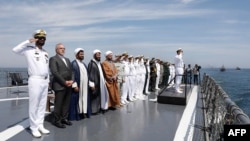 Local officials and navy personnel attend a joint Iranian, Russian and Chinese military drill in the Gulf of Oman, Iran, on March 12, 2025. (Iranian Army Office via AFP)