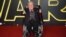 FILE - Britain Star Wars The Force Awakens Premiere: Kenny Baker poses for photographers upon arrival at the European premiere of the film 'Star Wars: The Force Awakens ' in London, Wednesday, Dec. 16, 2015.