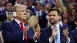 Republican presidential nominee and former U.S. President Donald Trump applauds with Republican vice presidential nominee J.D. Vance during Day 1 of the Republican National Convention at the Fiserv Forum in Milwaukee, Wisconsin, July 15, 2024. 