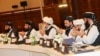 FILE - Members of the Taliban attend the second day of the Intra Afghan Dialogue talks in the Qatari capital, Doha, July 8, 2019. 