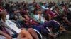 Tricycle drivers attend an outdoor movie screening held by a private organization, where cash and food donations are distributed to help them get by amid a tourism slump caused by the coronavirus disease (COVID-19) outbreak, in Phnom Penh, Cambodia, January 23, 2021. (REUTERS)