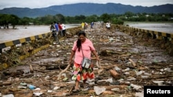 A pregnant woman is carried out of an area flooded by water brought by Hurricane Eta in Planeta, Honduras, Nov. 5, 2020. 