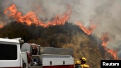 FILE - Firefighters battle the so-called Sand Fire in the Angeles National Forest near Los Angeles, California, July 25, 2016. 