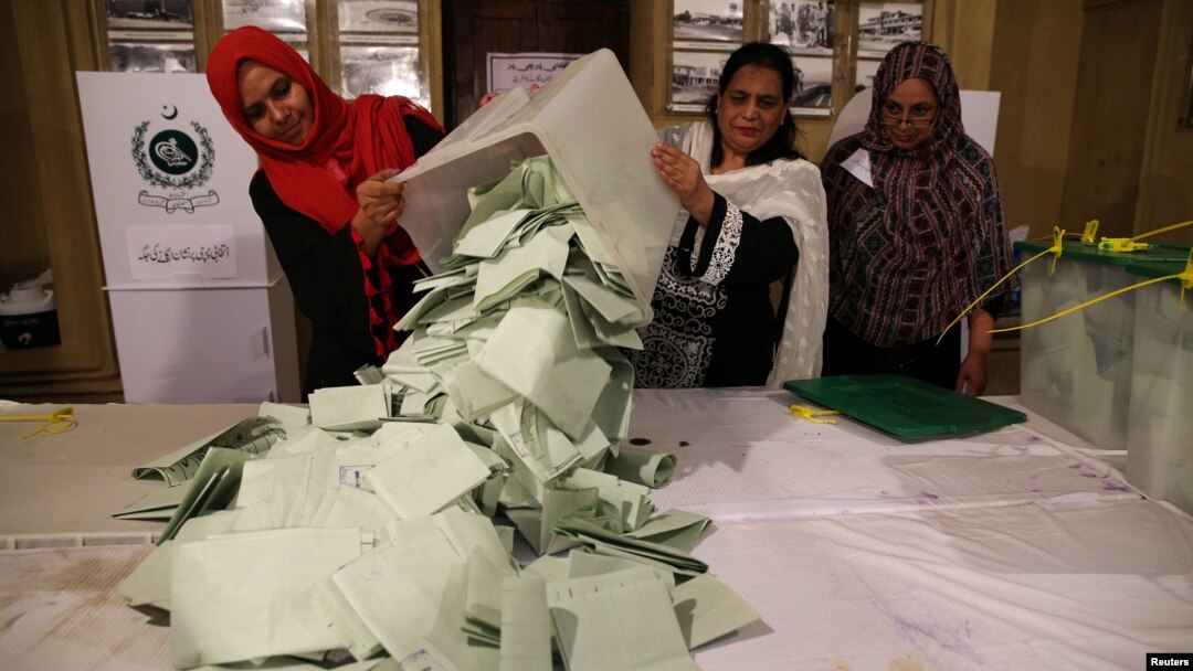 Election officials count ballots after polls closed during the general election in Islamabad, Pakistan, July 25, 2018.