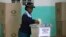 A member of the Zimbabwean police force casts her vote in the capital, Harare, July 14, 2013. 