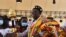 Le candidat à la présidentielle ivoirienne Kouadio Konan Bertin, en tenue de chef traditionnel, sourit à ses partisans lors de son investiture au Palais de la Culture d'Abidjan le 4 octobre 2020.