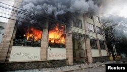 An exterior view of a building which was set alight by demonstrators during a protest against government plans to privatize health and education services, is seen in Tegucigalpa, Honduras, April 29, 2019. 