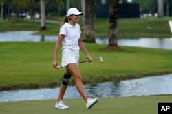 FILE - Kai Trump, granddaughter of former President Donald Trump, walks on the 18th green during the ProAm of the LIV Golf Team Championship at Trump National Doral Golf Club in Florida, Oct. 27, 2022.