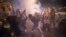 Protesters react to tear gas fired by French riot police in Marseille, southern France,  June 6, 2020, during a protest against the recent death of George Floyd. 